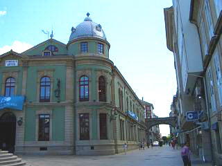 A street with a wall gate in the distance